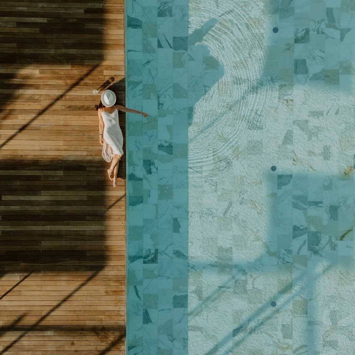 Woman relaxing by the poolside at Panama 3 Maggio during sunset.